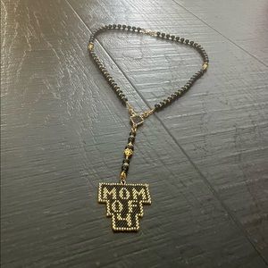 Handcrafted black and gold beaded “Mom of 4” necklace.